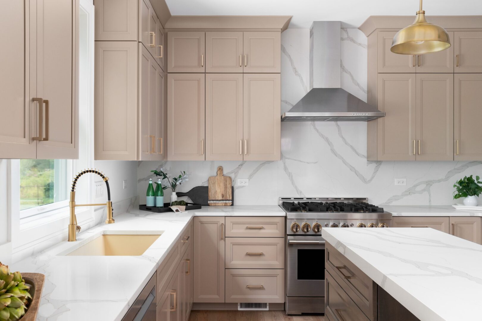 Modern kitchen with beige cabinets and island.