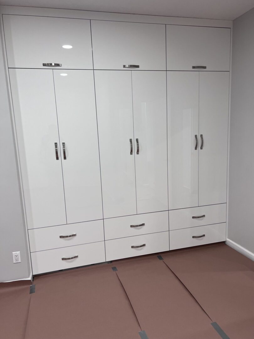 White wardrobe with multiple doors and drawers.