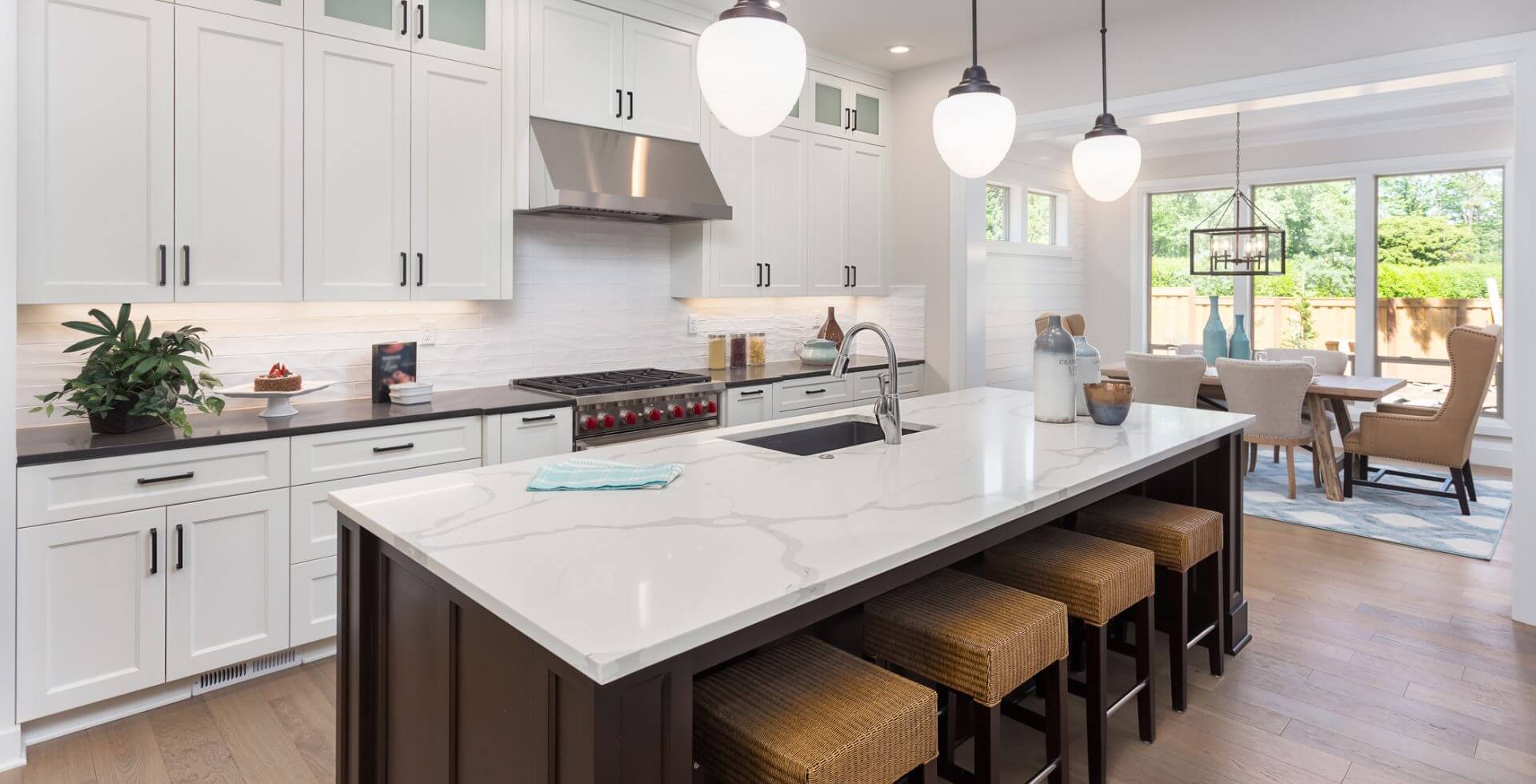 Modern kitchen with island and dining area.
