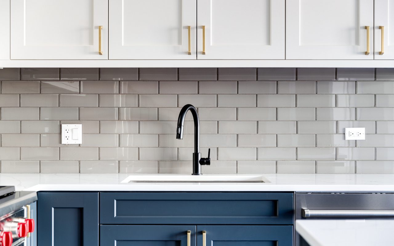 Modern kitchen with gray tile backsplash.