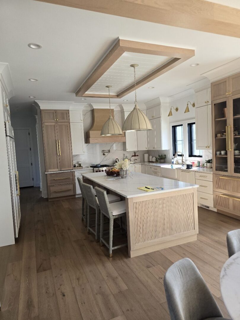 Modern kitchen with island and pendant lights.