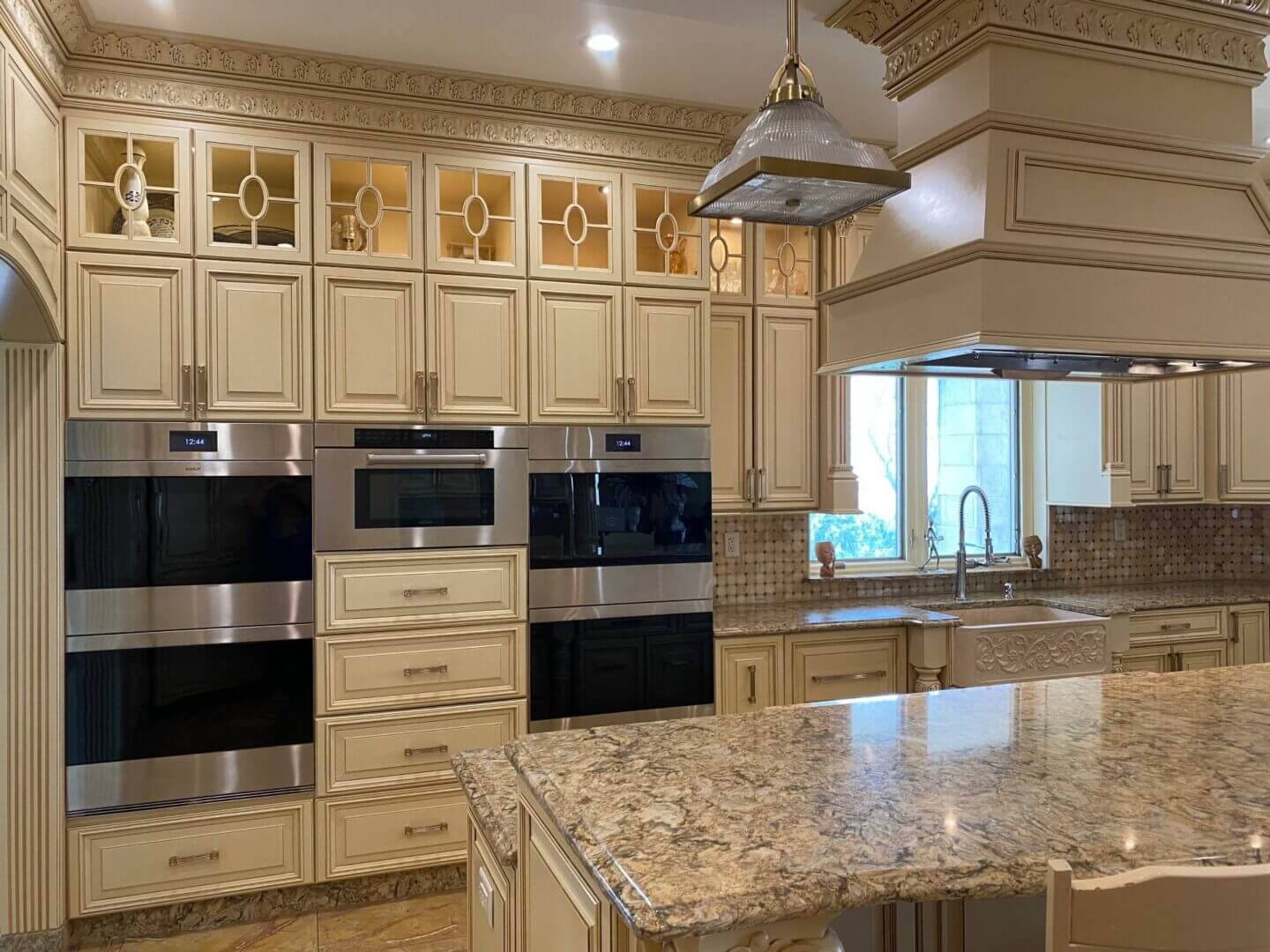 Elegant kitchen with cream cabinetry and granite countertops.