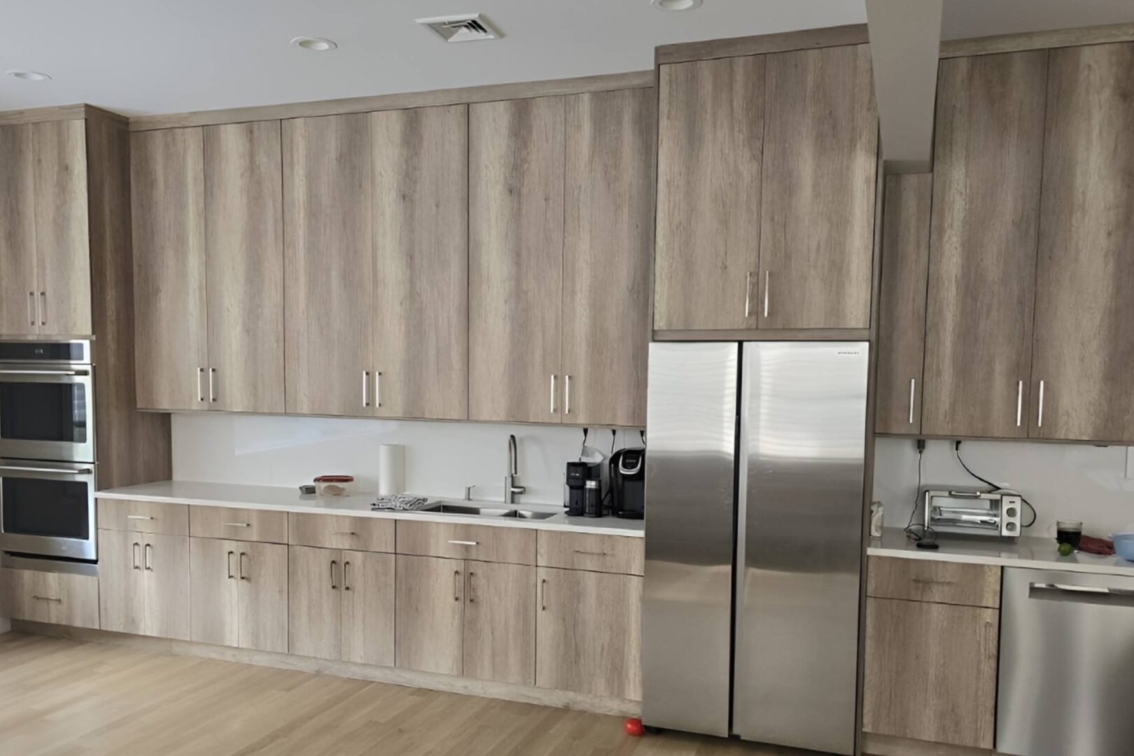 Modern kitchen with wooden cabinets and stainless steel appliances.