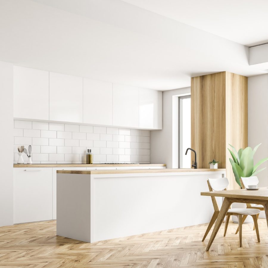 Bright modern kitchen with white cabinetry and wooden accents.