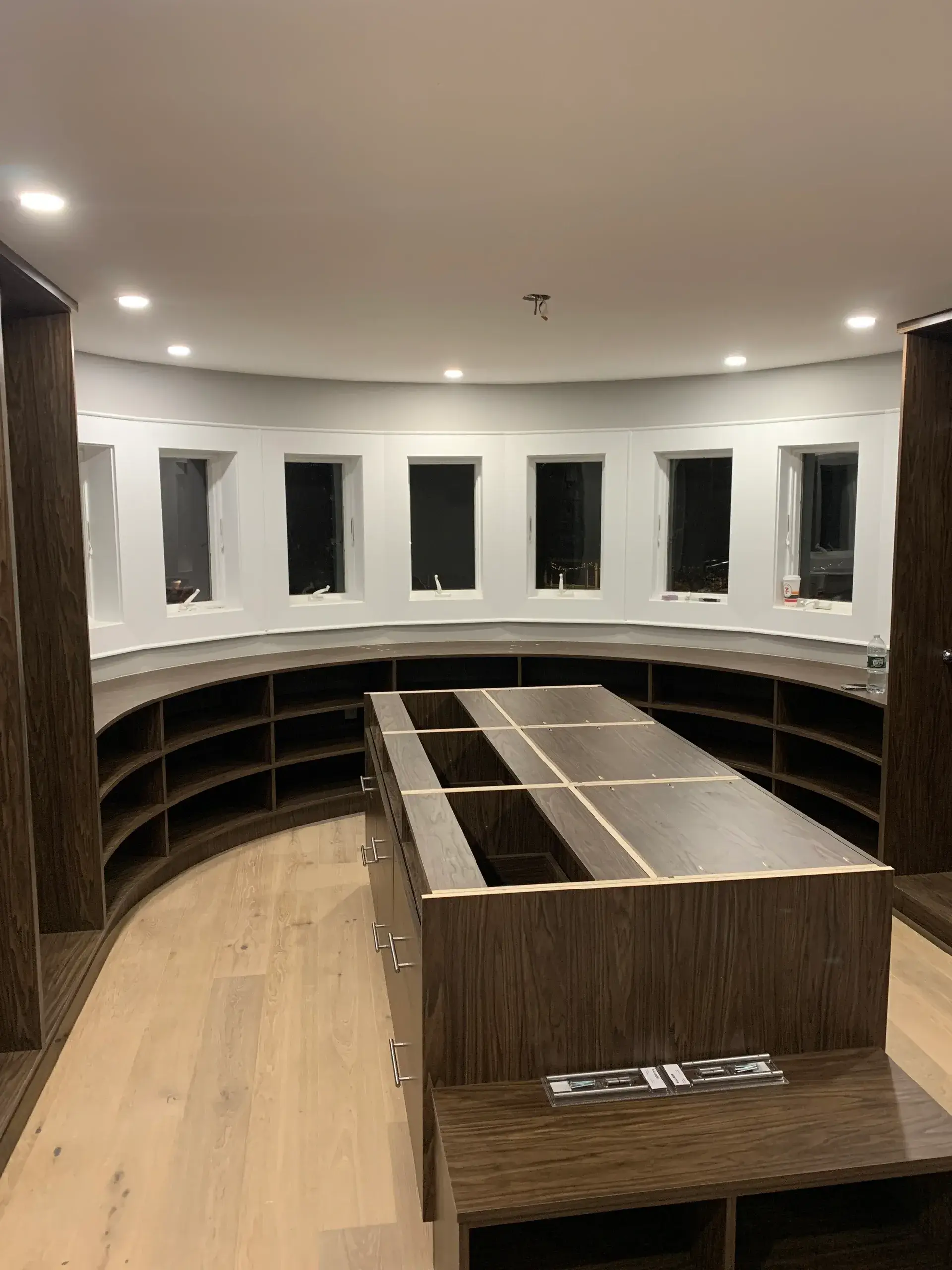 Spacious walk-in closet with wooden shelves.