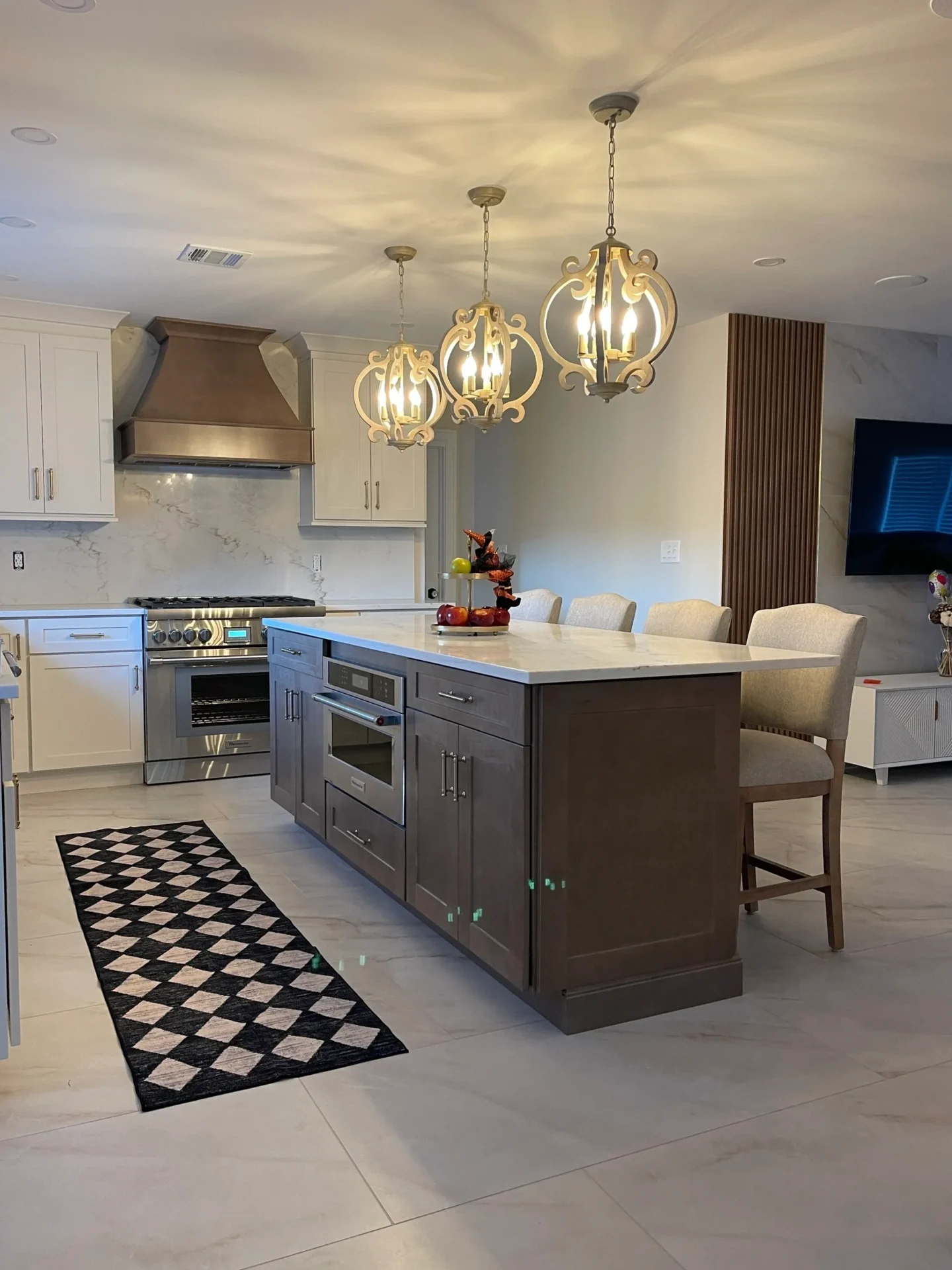 Modern kitchen with island and pendant lights.