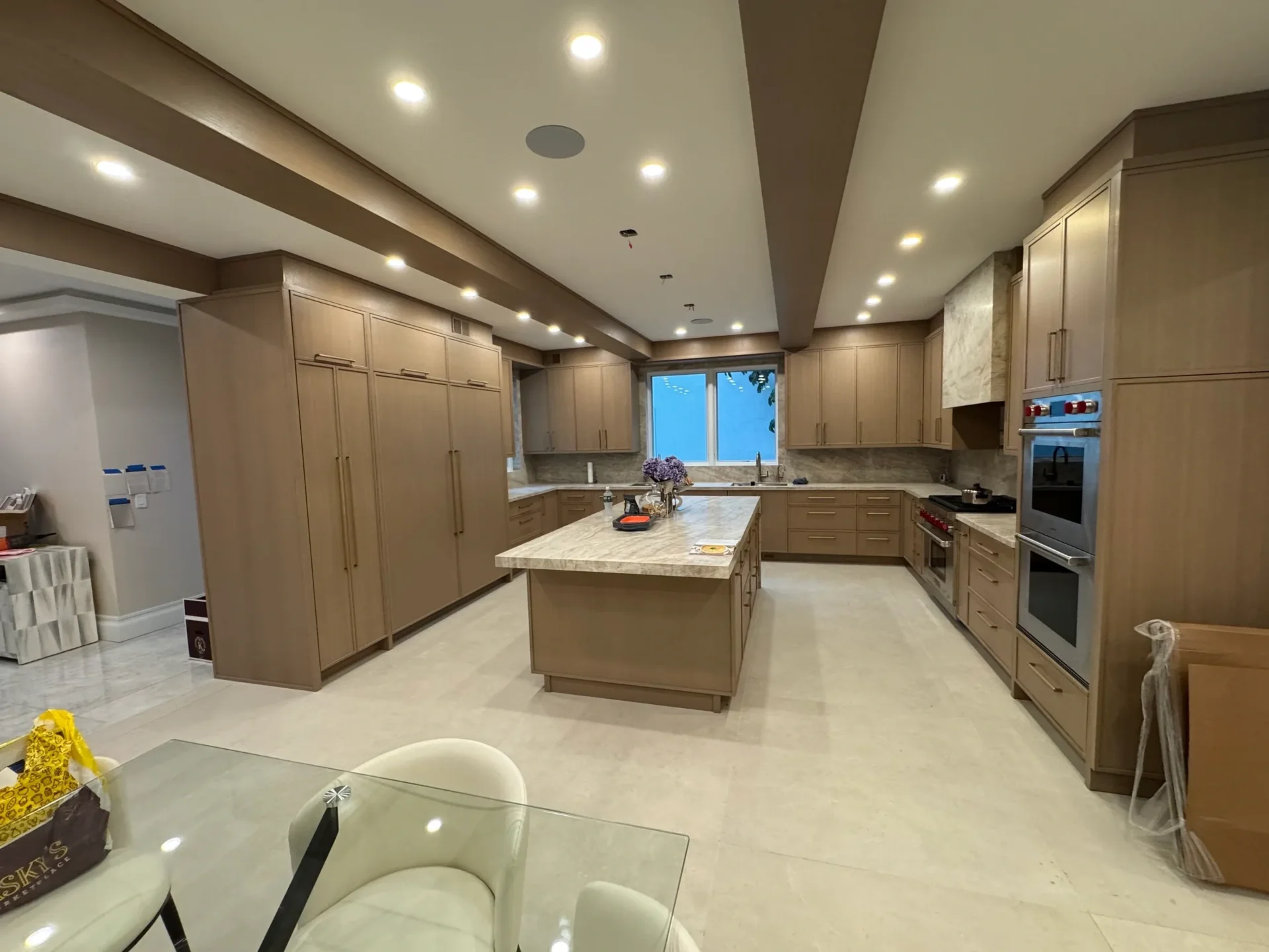 Modern kitchen with island and wooden cabinets.