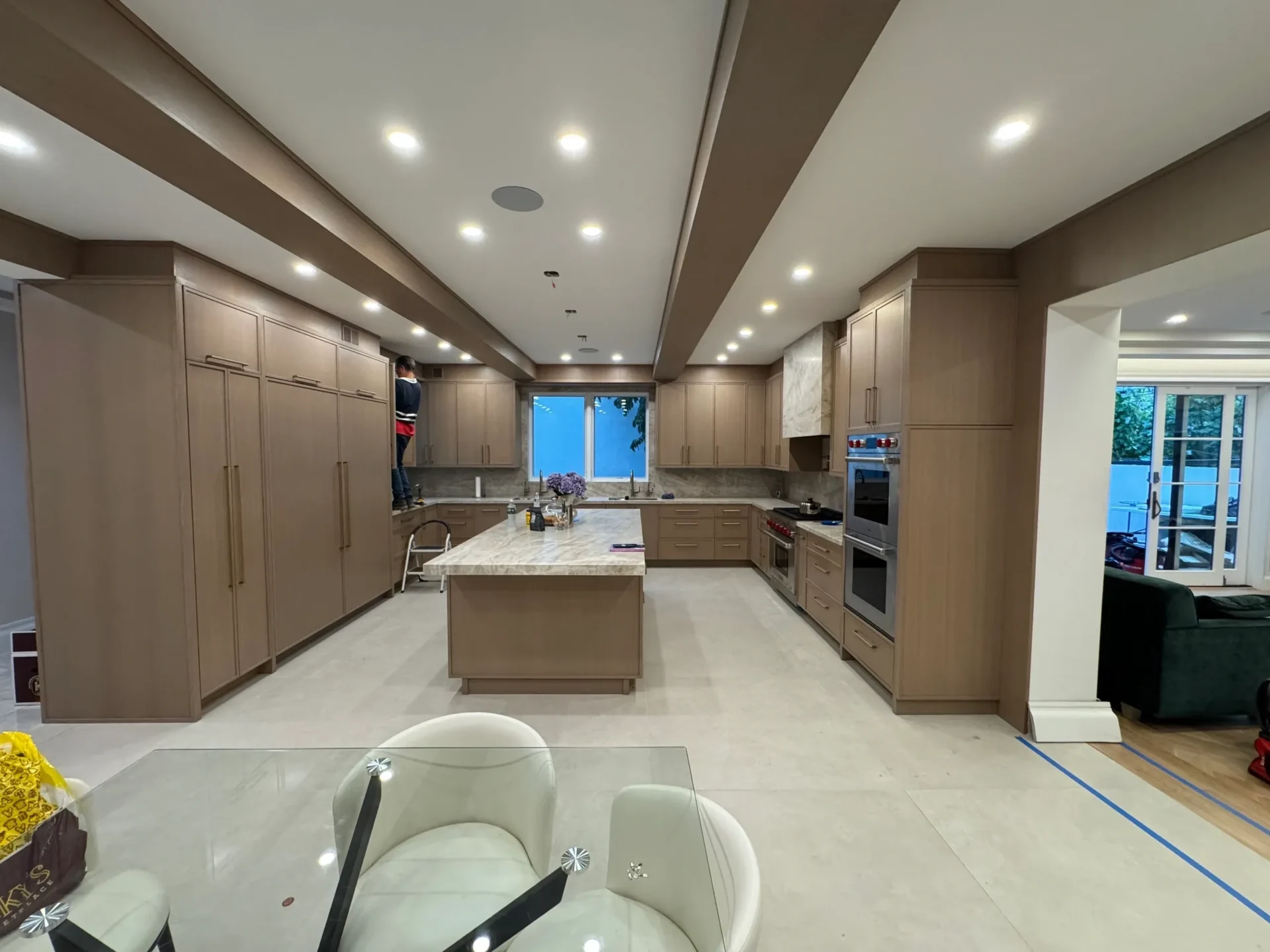 Modern kitchen with island and dining area.