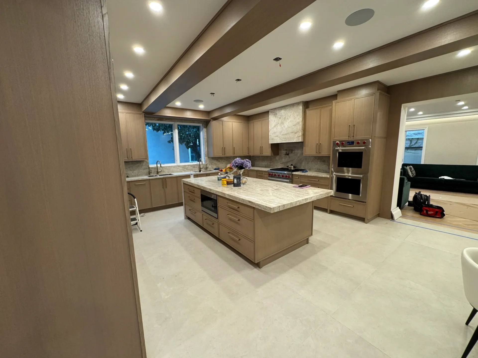 Modern kitchen with island and wooden cabinets.