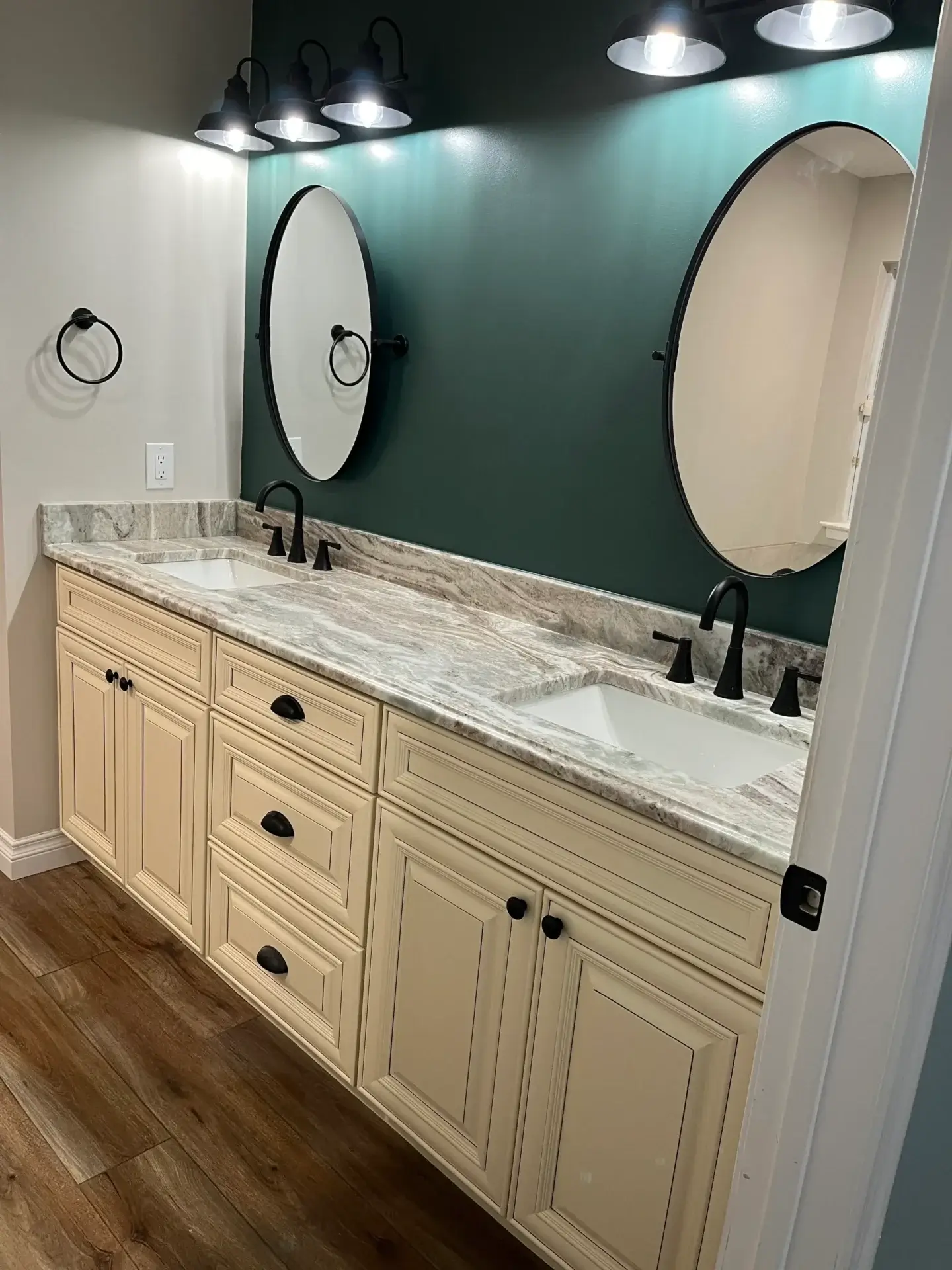 Modern bathroom with double sinks and mirrors.